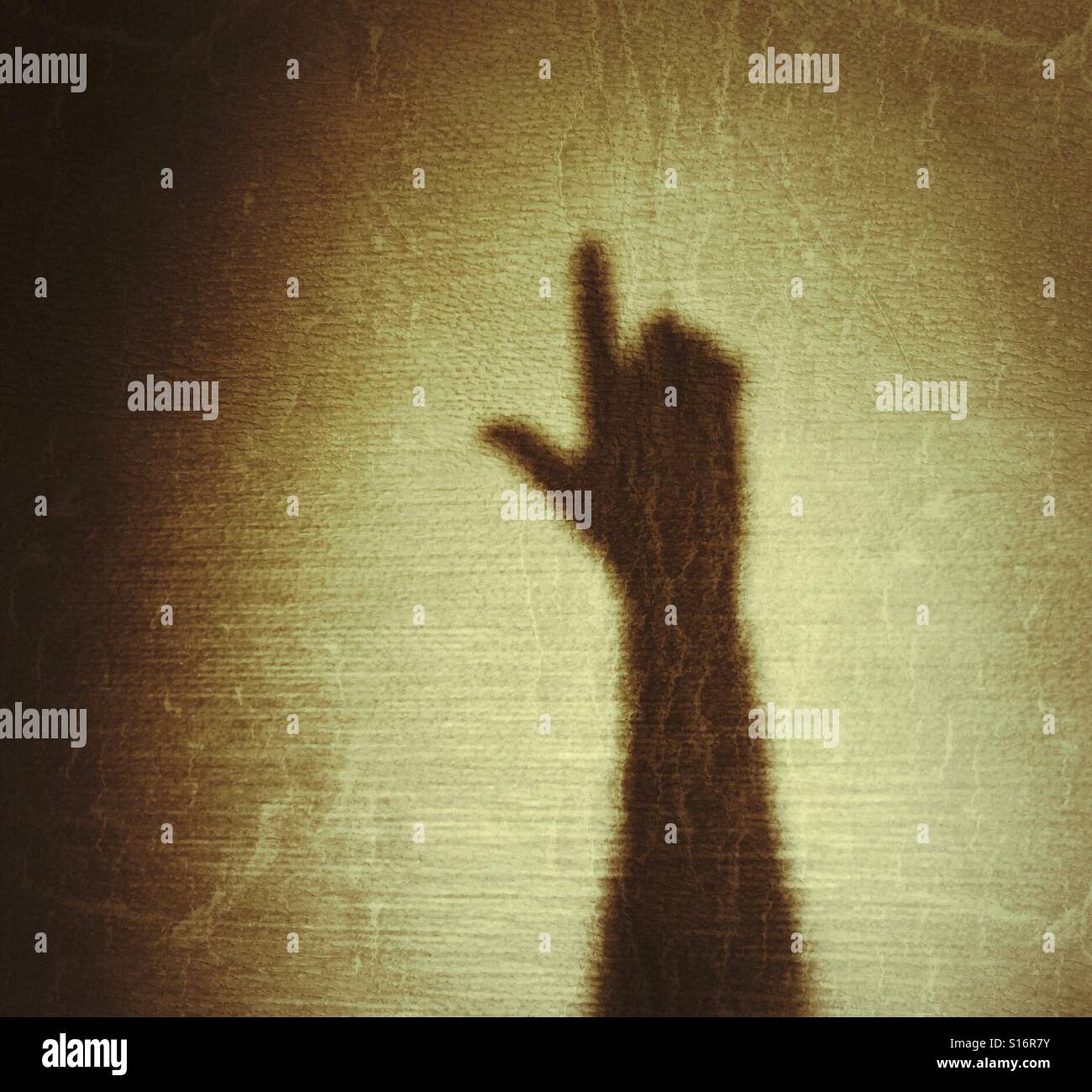 Shadow hand pointing upwards like a gun - Smartphone Captured Stock Image