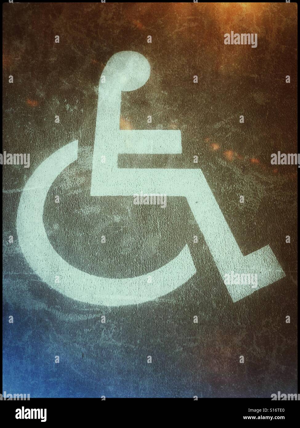 A retro film effect image of a disabled persons parking space.  The symbol of a person sitting in a wheel chair identifies this area as one that is dedicated for use by people who have mobility issues - Smartphone Captured Stock Image