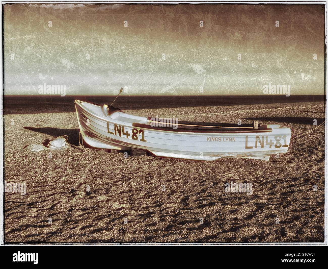 An abandoned boat lies on the beach near the River Glaven in Blakeney National Nature Reserve in Norfolk, England, UK. Photo Credit - © COLIN HOSKINS. - Smartphone Captured Stock Image