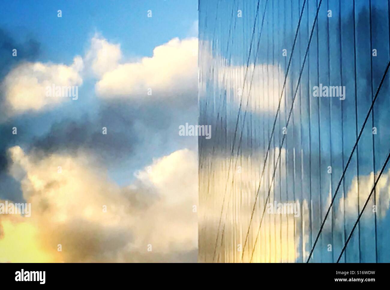 Mirrored image of clouds on the side of an office building in Southwark, south London, U.K. - Smartphone Captured Stock Image