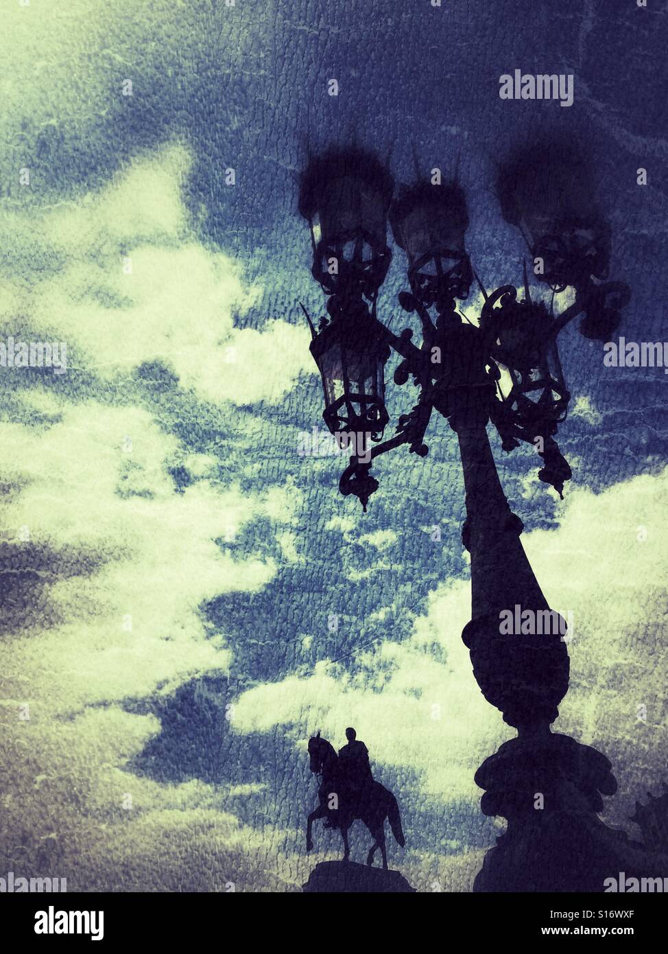 Shadow of a man statue riding a horse and vintage street lamps - Smartphone Captured Stock Image