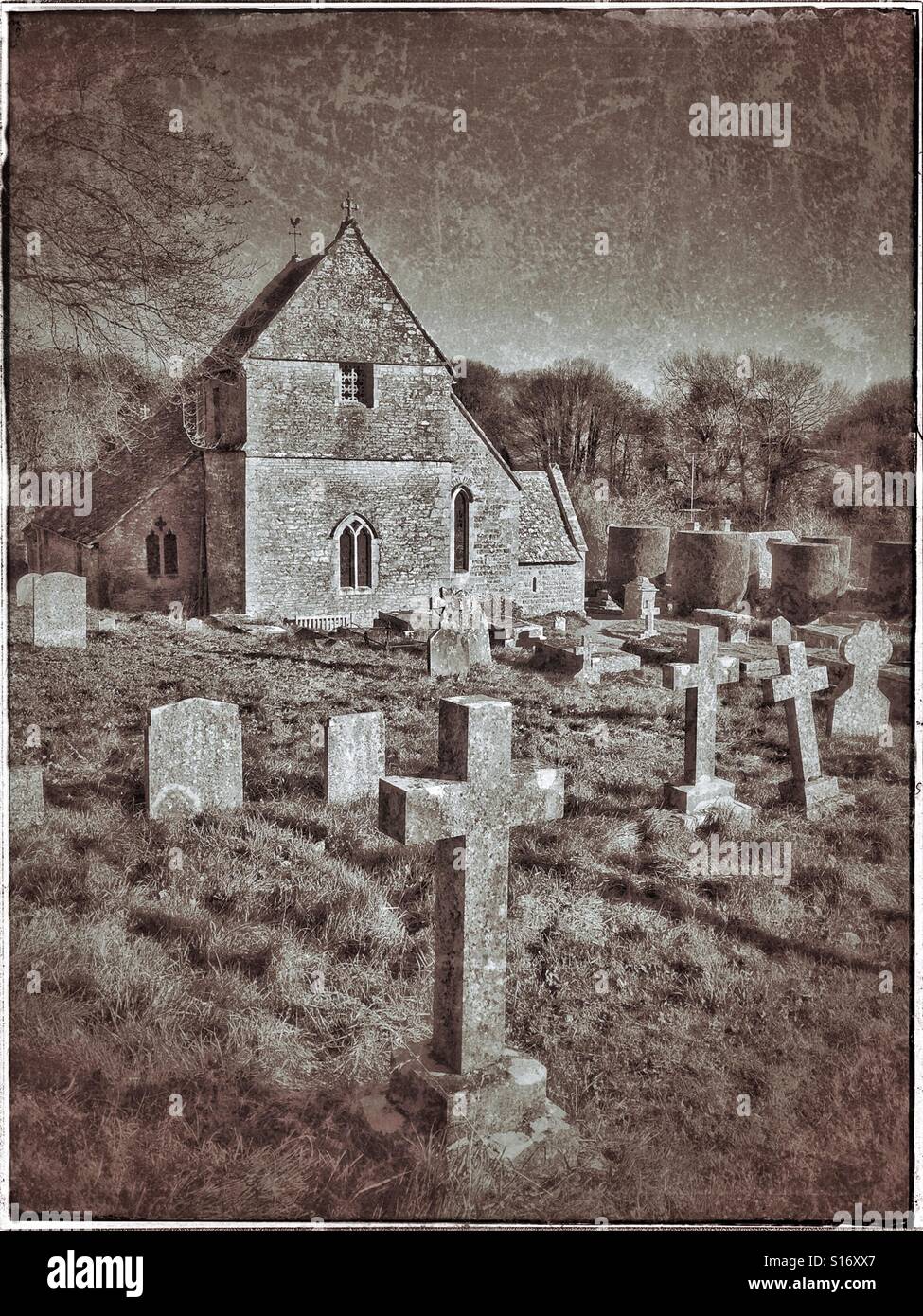 The Christian Church of St. Peter in Duntisbourne Abbots, Gloucestershire, England. A retro & grunge effect picture with copy space & no people. Photo Credit - © COLIN HOSKINS. - Smartphone Captured Stock Image
