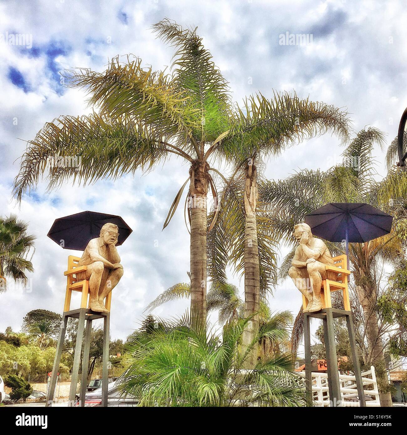 Statues of men waiting in the Cedros Avenue Design District Solana Beach California Stock Photo
