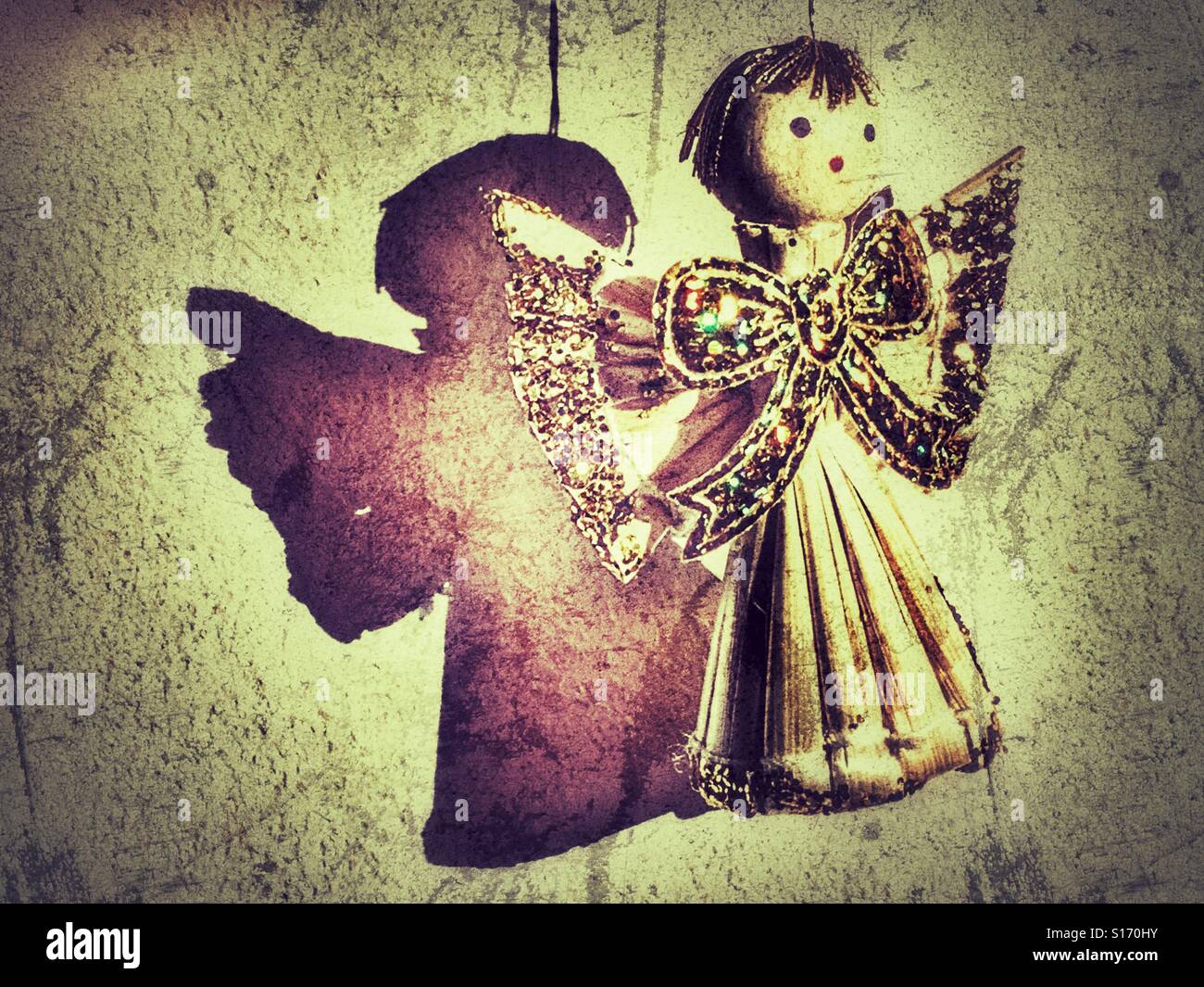 Christmas decorations. Handmade straw angel decorated with gold glitter. - Smartphone Captured Stock Image