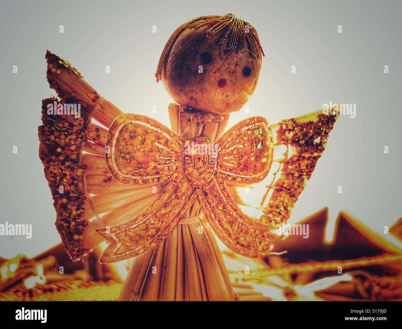 Christmas tree decoration. Handmade straw angel decorated with gold glitter - Smartphone Captured Stock Image