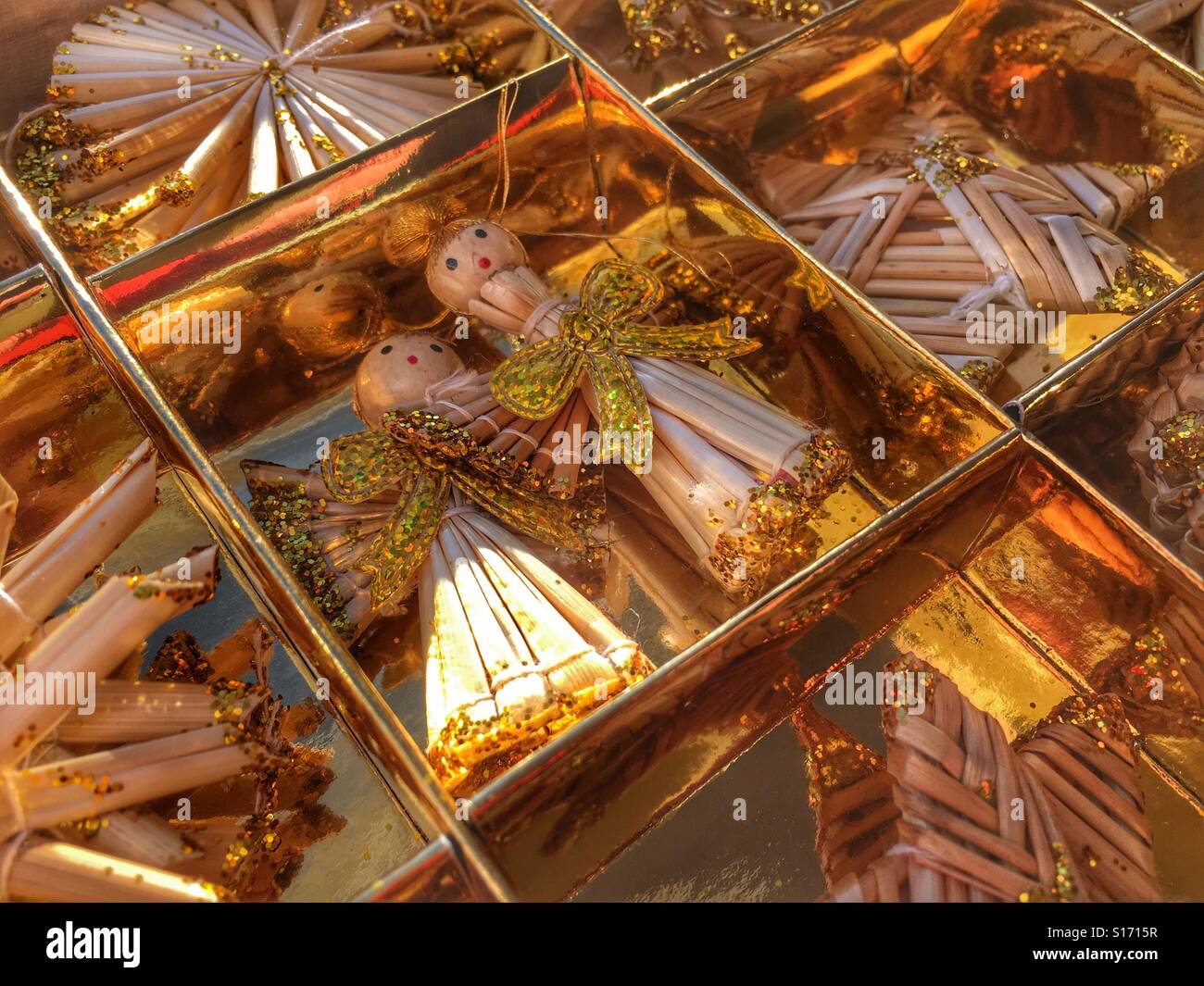 Christmas decorations. Straw angels decorated with gold glitter.. - Smartphone Captured Stock Image