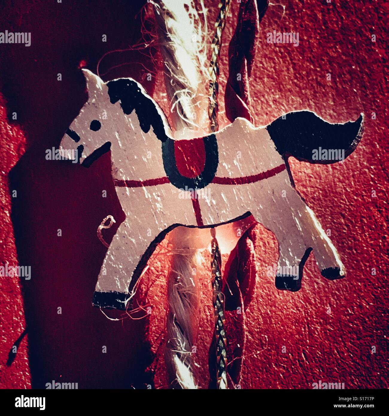String decorated with little wooden horse, an alternative to ribbon for wrapping presents - Smartphone Captured Stock Image