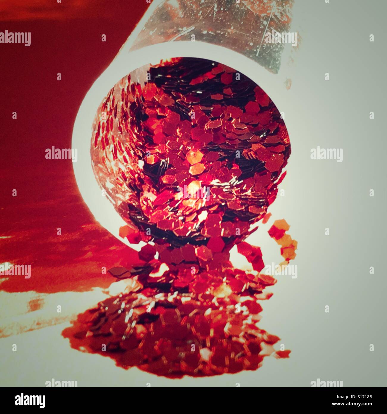 Clear plastic tube of red glitter - Smartphone Captured Stock Image