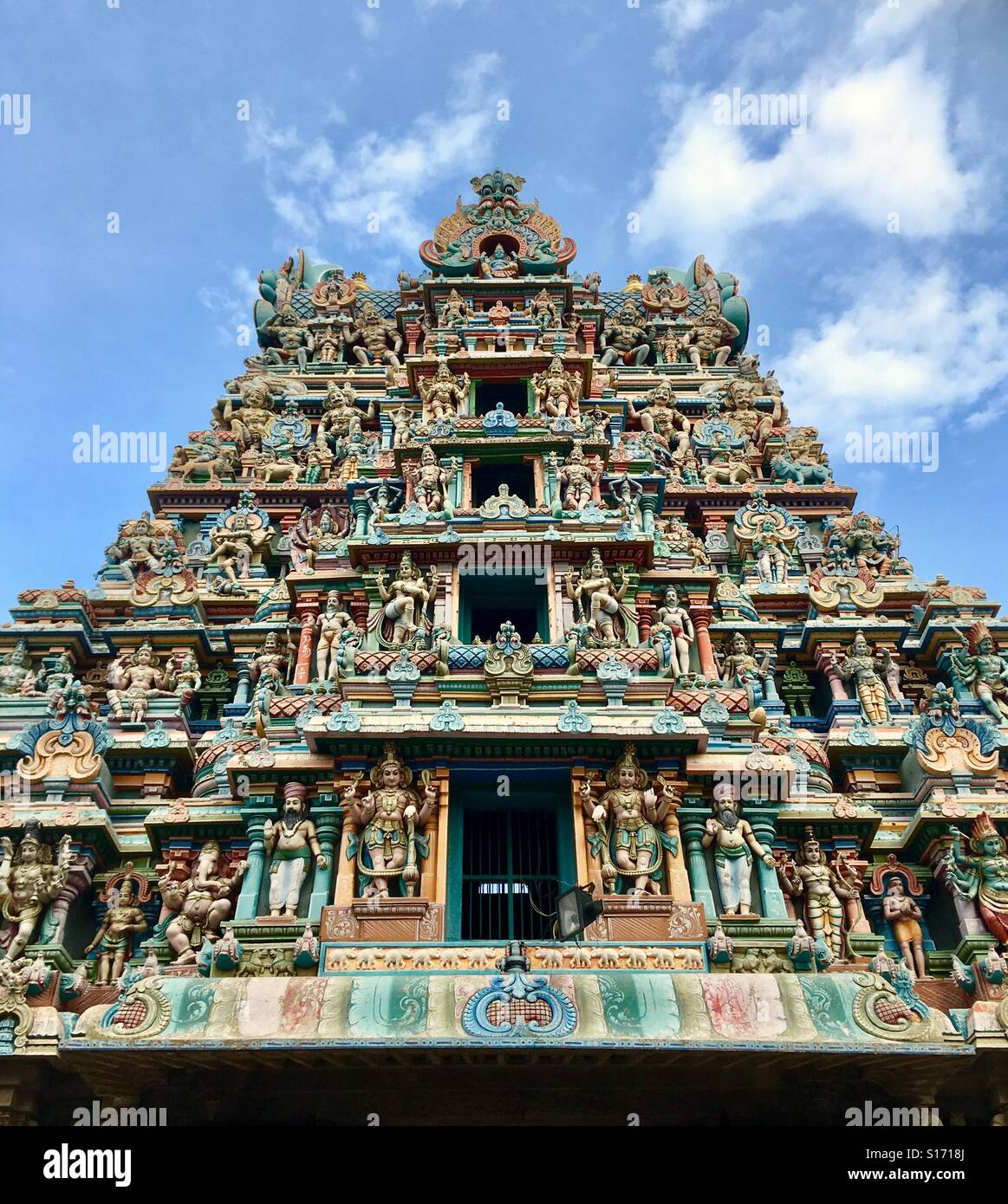 Low-angle view of colorful gopura tower with Hindu deities inside ...