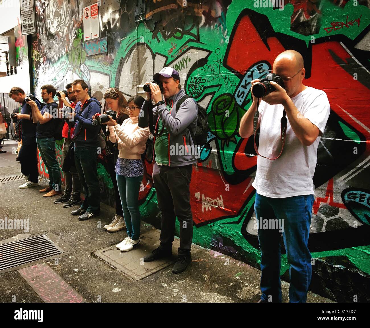 Photography students taking photos as part of a photography walking Tour - Smartphone Captured Stock Image