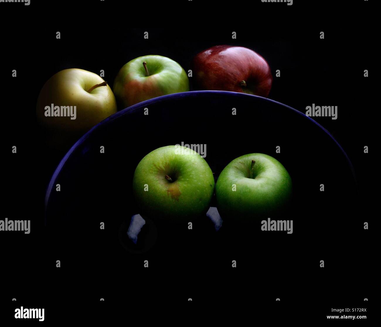 Bowl of apples in dramatic raking light - Smartphone Captured Stock Image