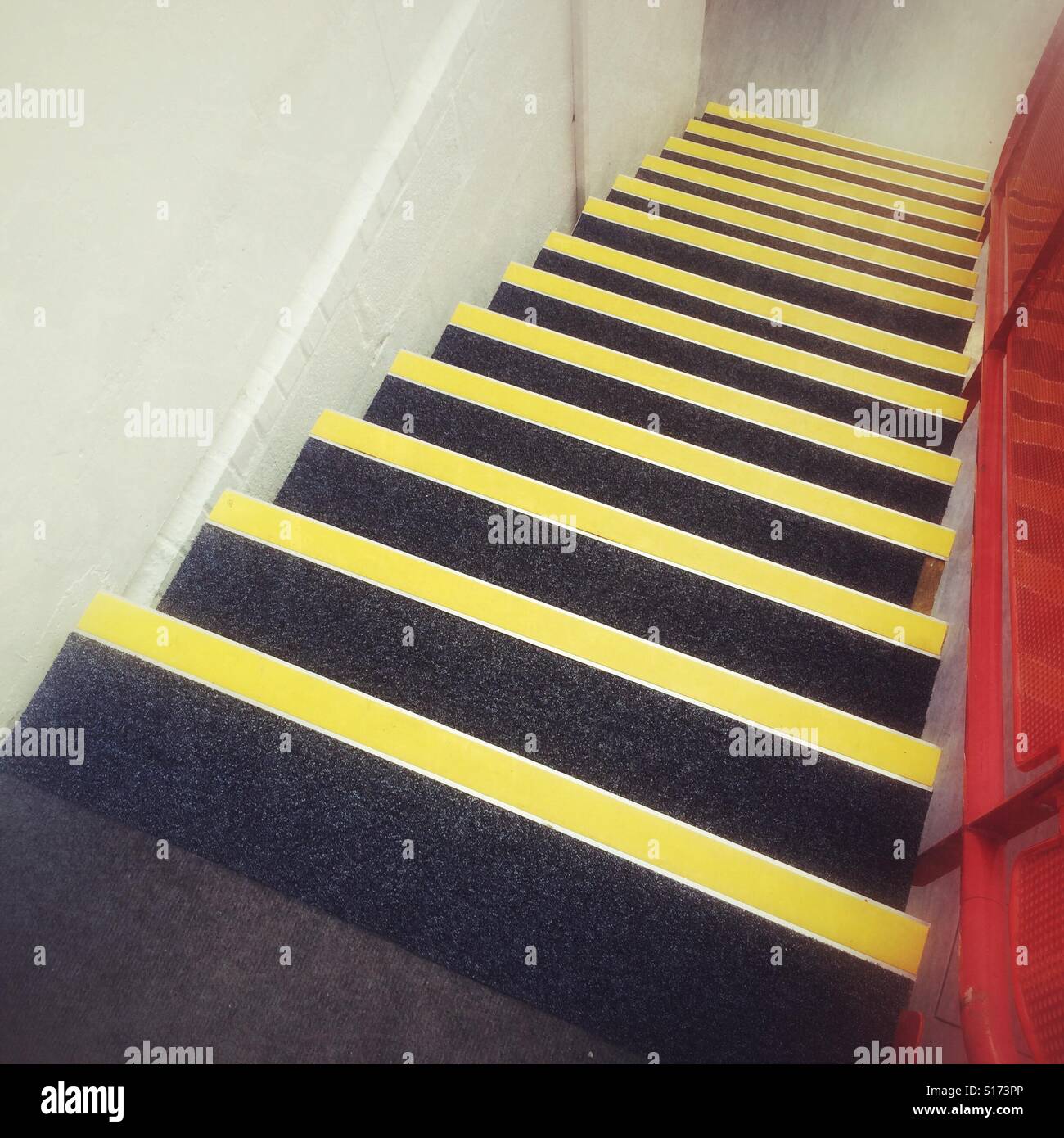 Stairs marked with yellow safety strips Stock Photo