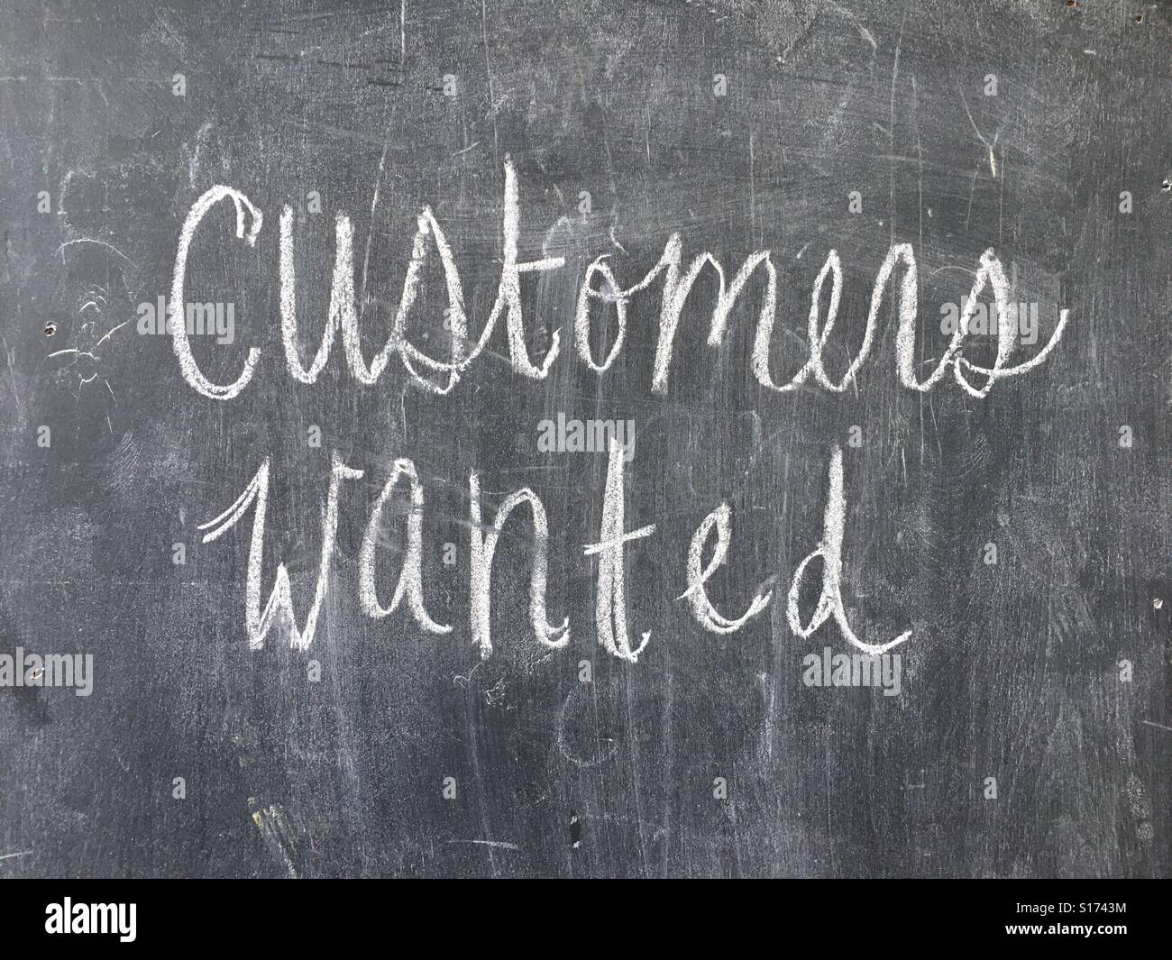 Customers wanted  sign on chalk board - Smartphone Captured Stock Image