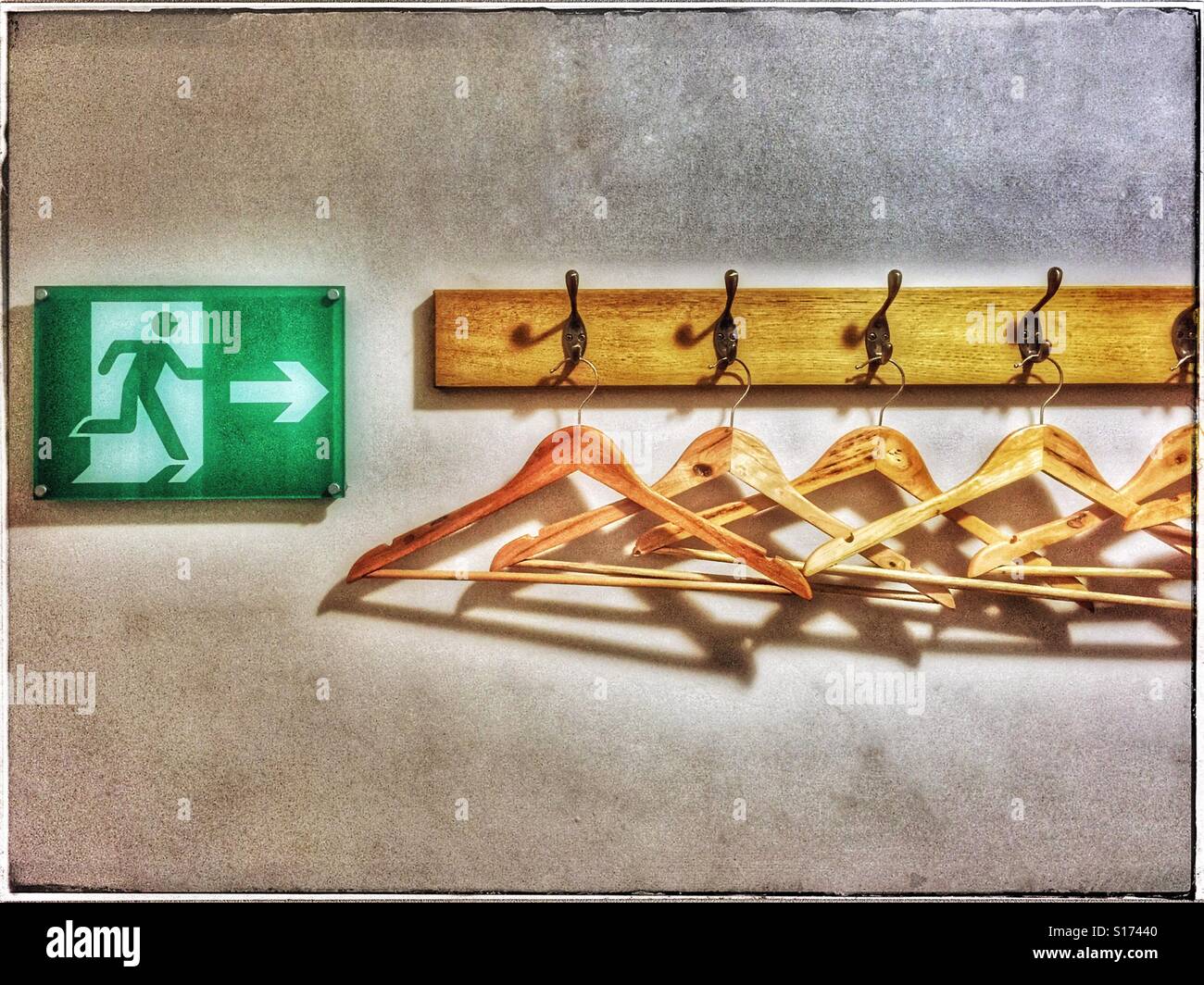 'In the unlikely event of an emergency evacuation, do not stop to collect your personal belongings. Instead, immediately make your way to the nearest emergency exit' Humour illustrated! © C. HOSKINS. - Smartphone Captured Stock Image