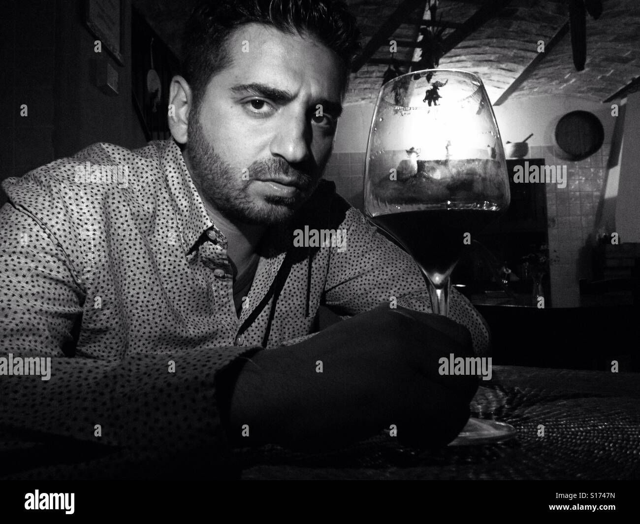 Handsome Italian man toasting with glass of wine - Smartphone Captured Stock Image