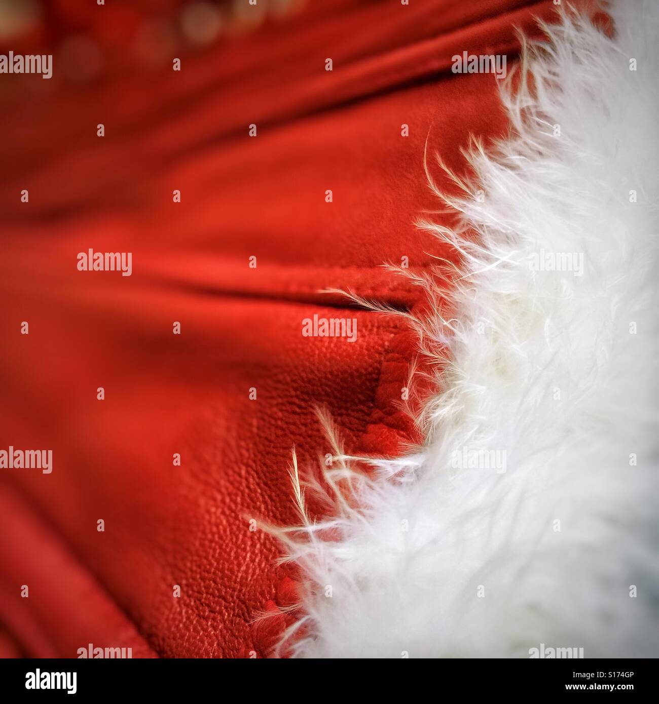 Close up of a red leather Christmas outfit with white cut edging - Smartphone Captured Stock Image