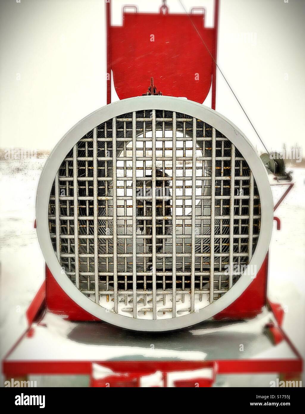 a polar bear trap, baited with seal-oil-soaked canvas, stands in Churchill, Canada. - Smartphone Captured Stock Image