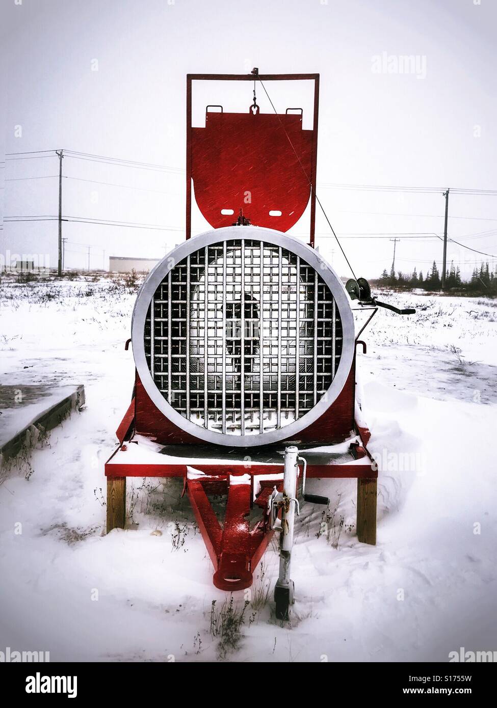 a trailer-mounted polar bear trap, baited with seal-oil-soaked canvas, stands in Churchill, Canada. - Smartphone Captured Stock Image