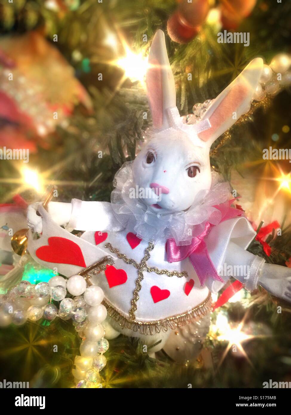A white rabbit dressed as a court jester is a beautiful Christmas ornament on a sparkling brightly decorated Christmas tree - Smartphone Captured Stock Image