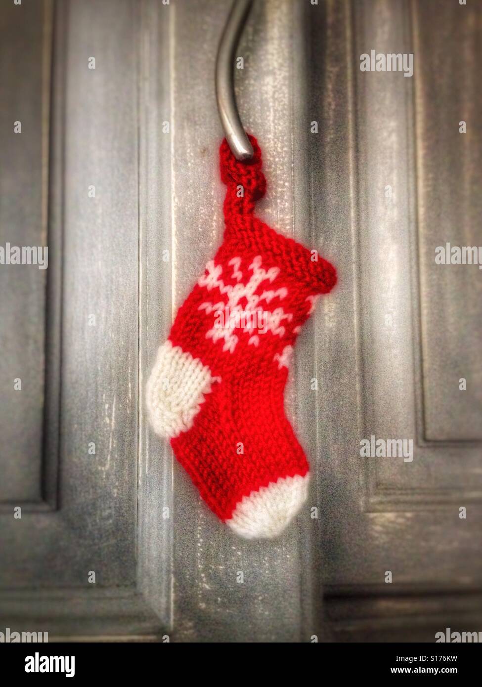 A Christmas Stocking Decoration Hanging From A Cupboard Door