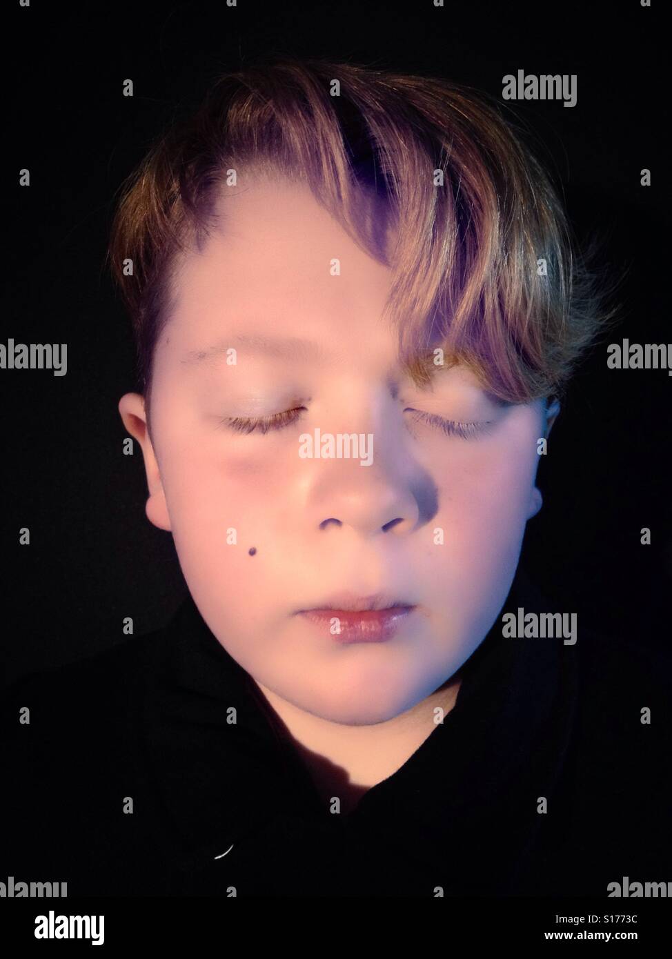 Ginger haired 11-year old boy with eyes closed - Smartphone Captured Stock Image
