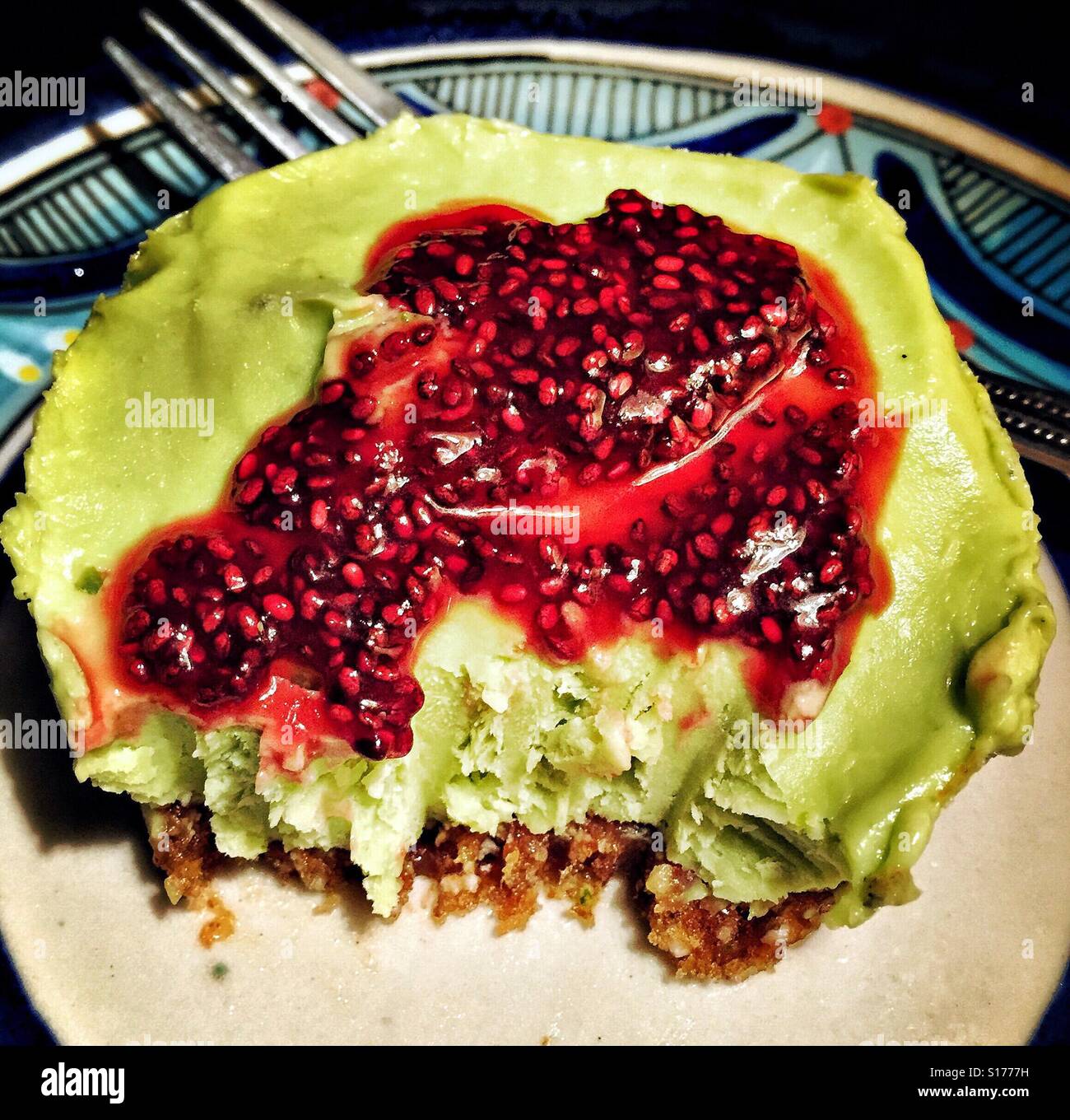 Key lime and avocado frozen dessert tart with flor de Jamaica sauce. Stock Photo
