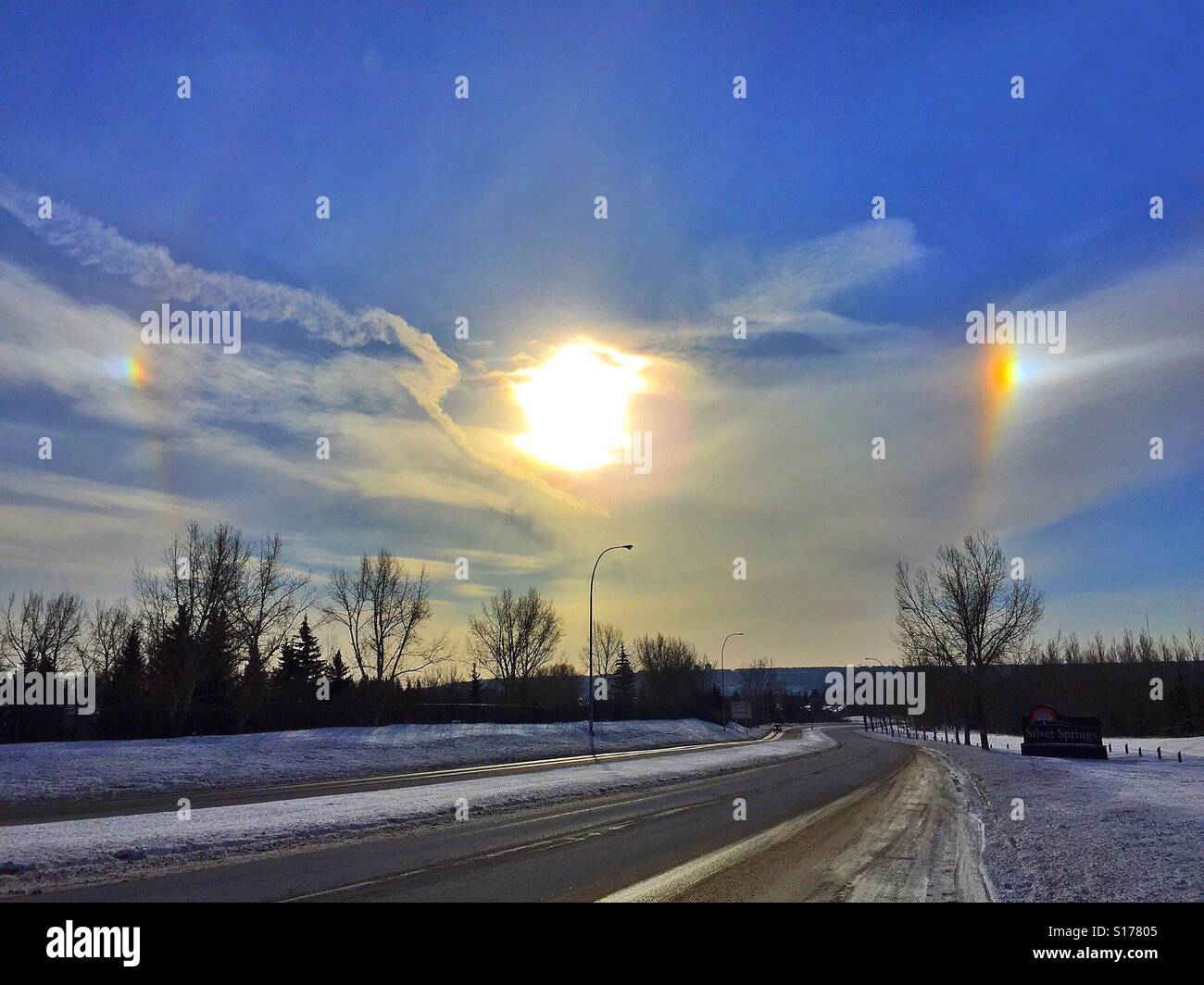 Bright sun,sun dogs, and jet stream - Smartphone Captured Stock Image