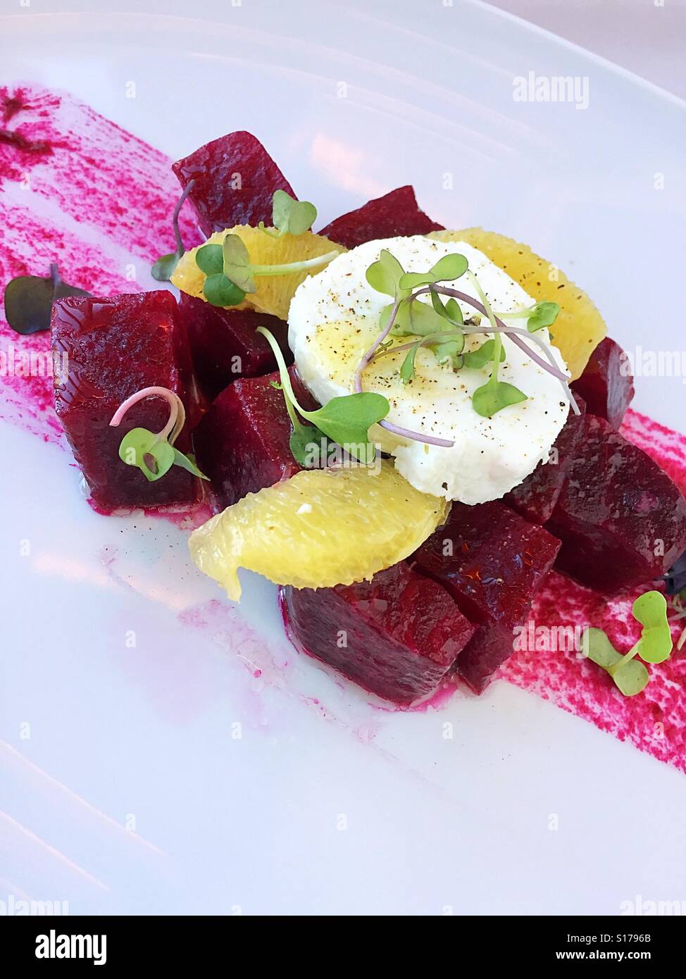 Fresh organic beets and cheese salad presentation at upscale luxury NYC restaurant - Smartphone Captured Stock Image