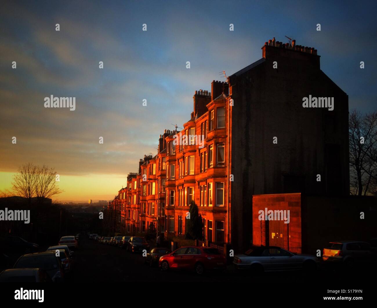 Red sandstone tenements in Glasgow reflecting the sunrise. Stock Photo
