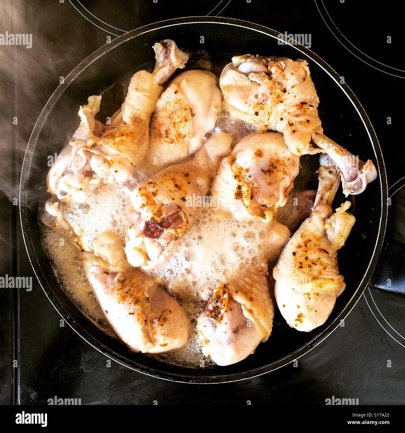 Chicken legs cooking in pan Stock Photo Alamy