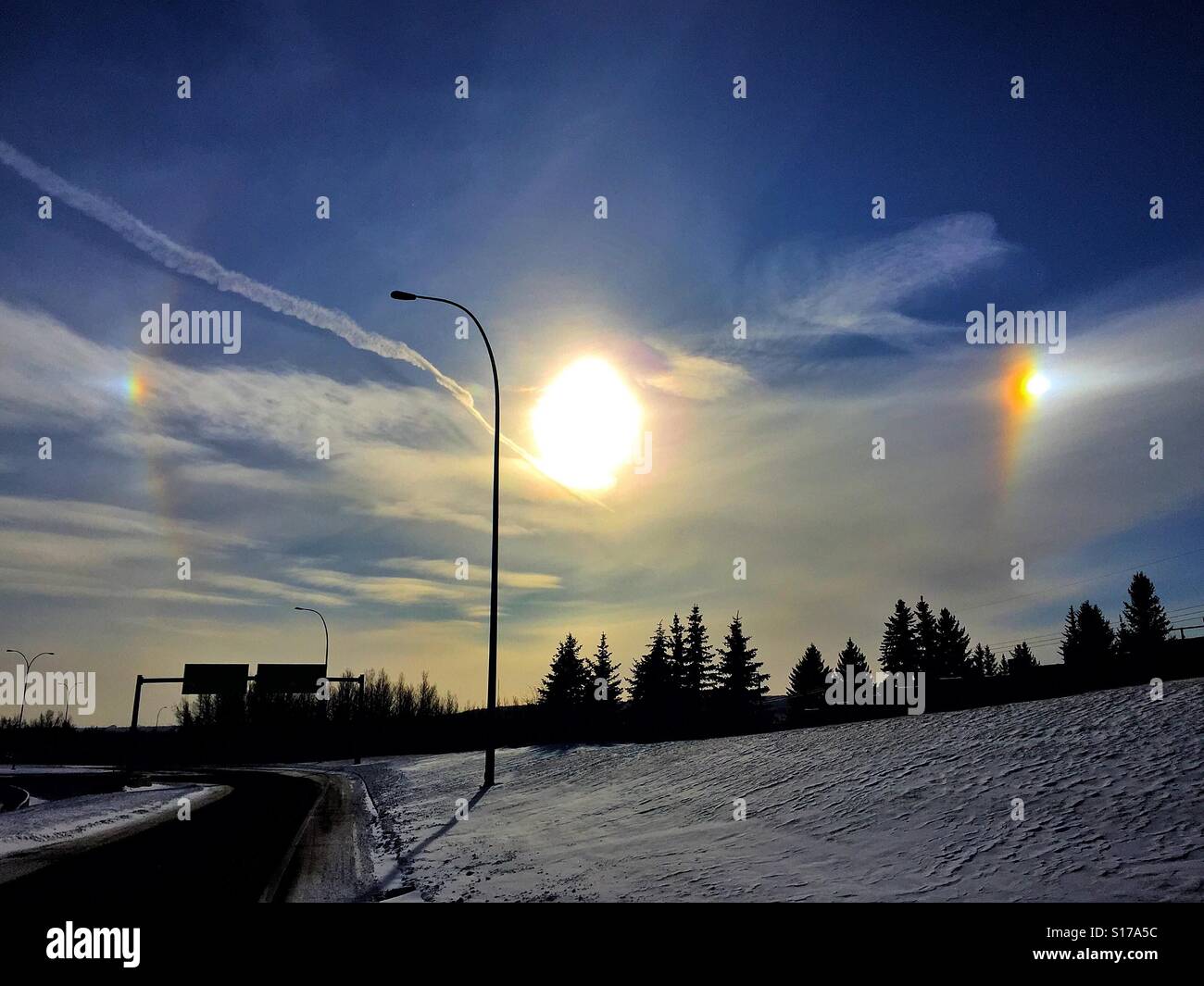 Bright sun, sun dogs, and jet stream - Smartphone Captured Stock Image