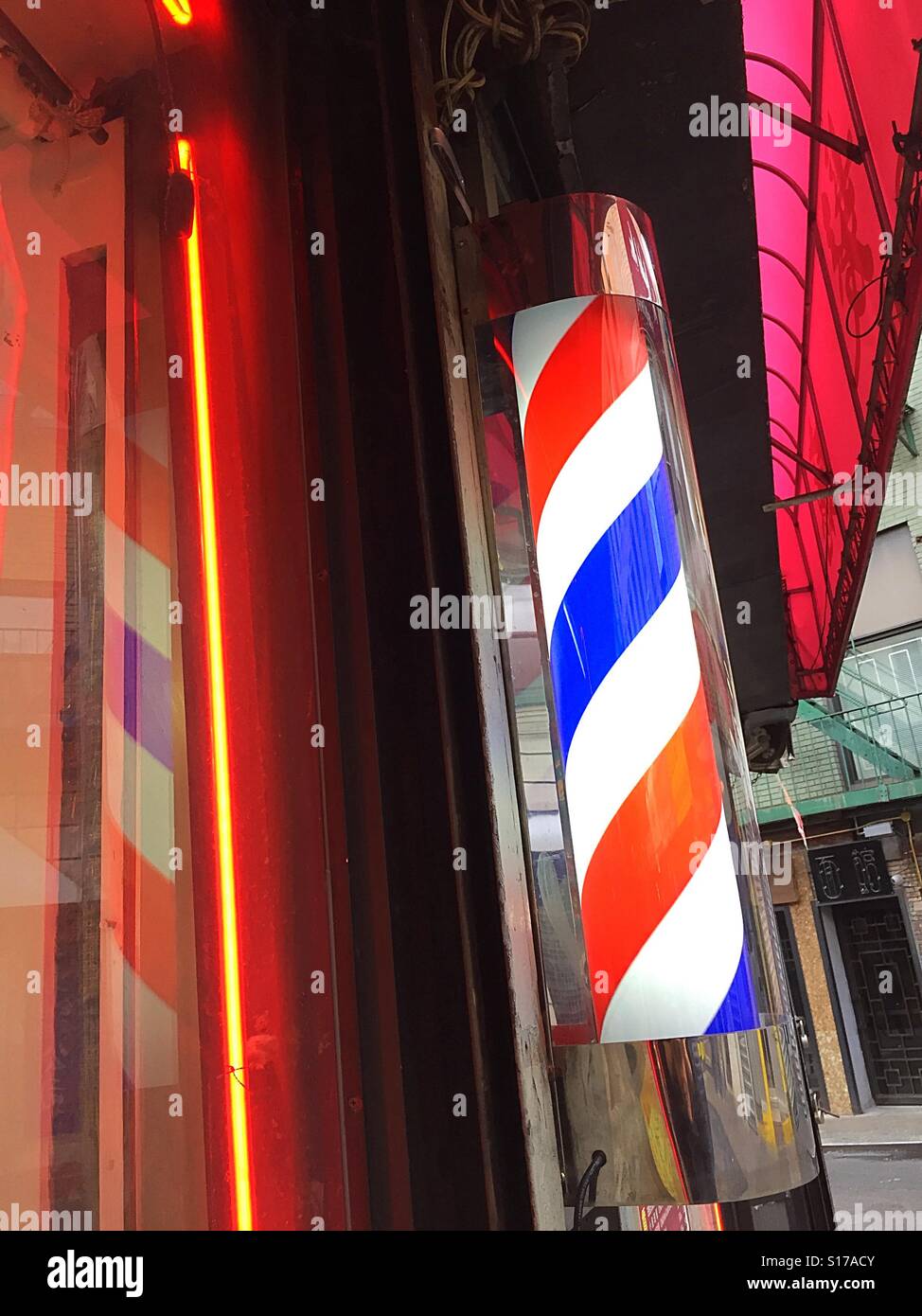 An old-fashioned rotating red white and blue Barber shop pole - Smartphone Captured Stock Image