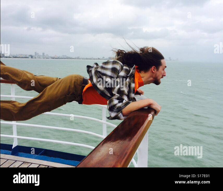 Windy balcony over ocean causes man to fly Stock Photo Alamy