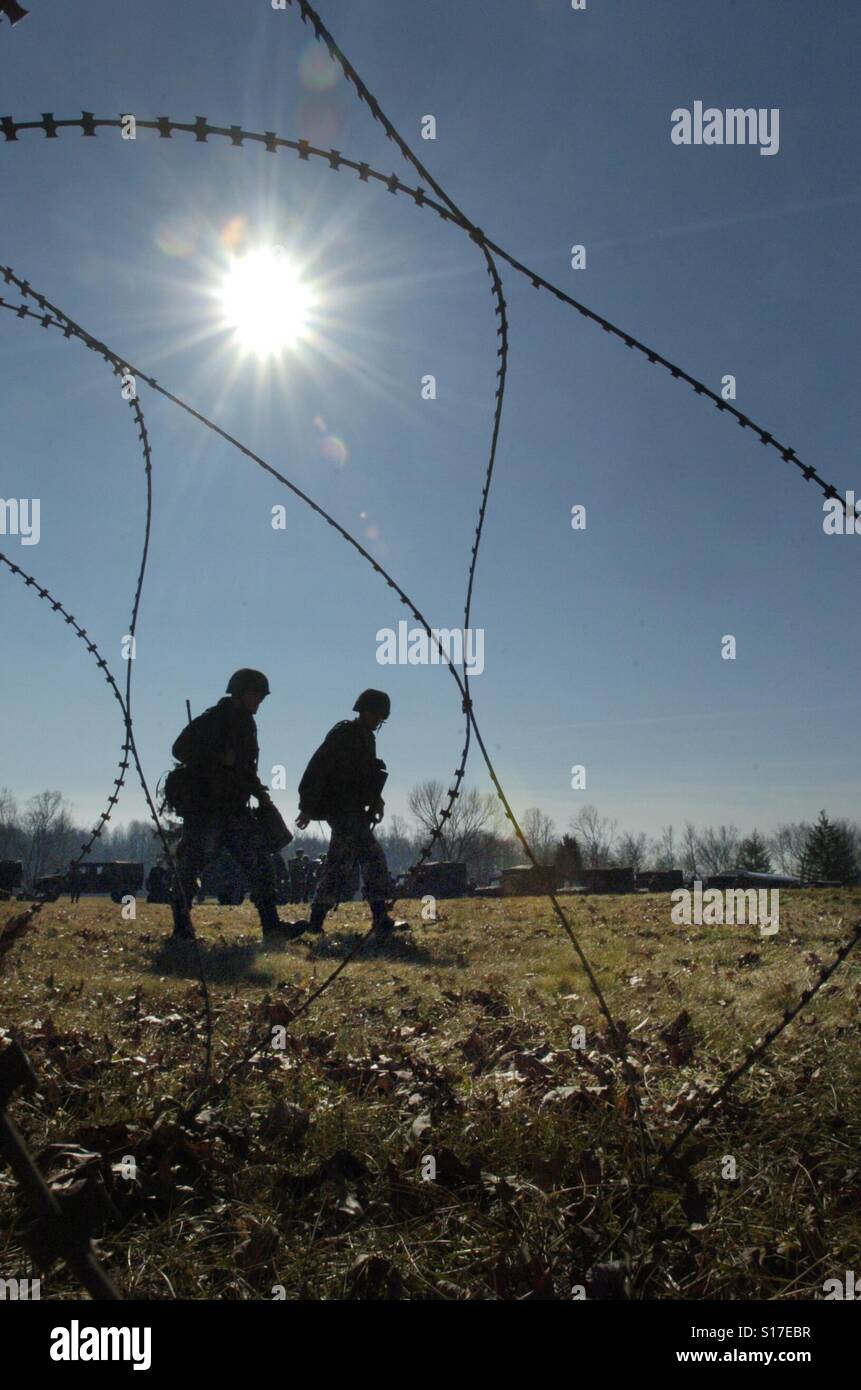 Solders framed by barbed wire. - Smartphone Captured Stock Image