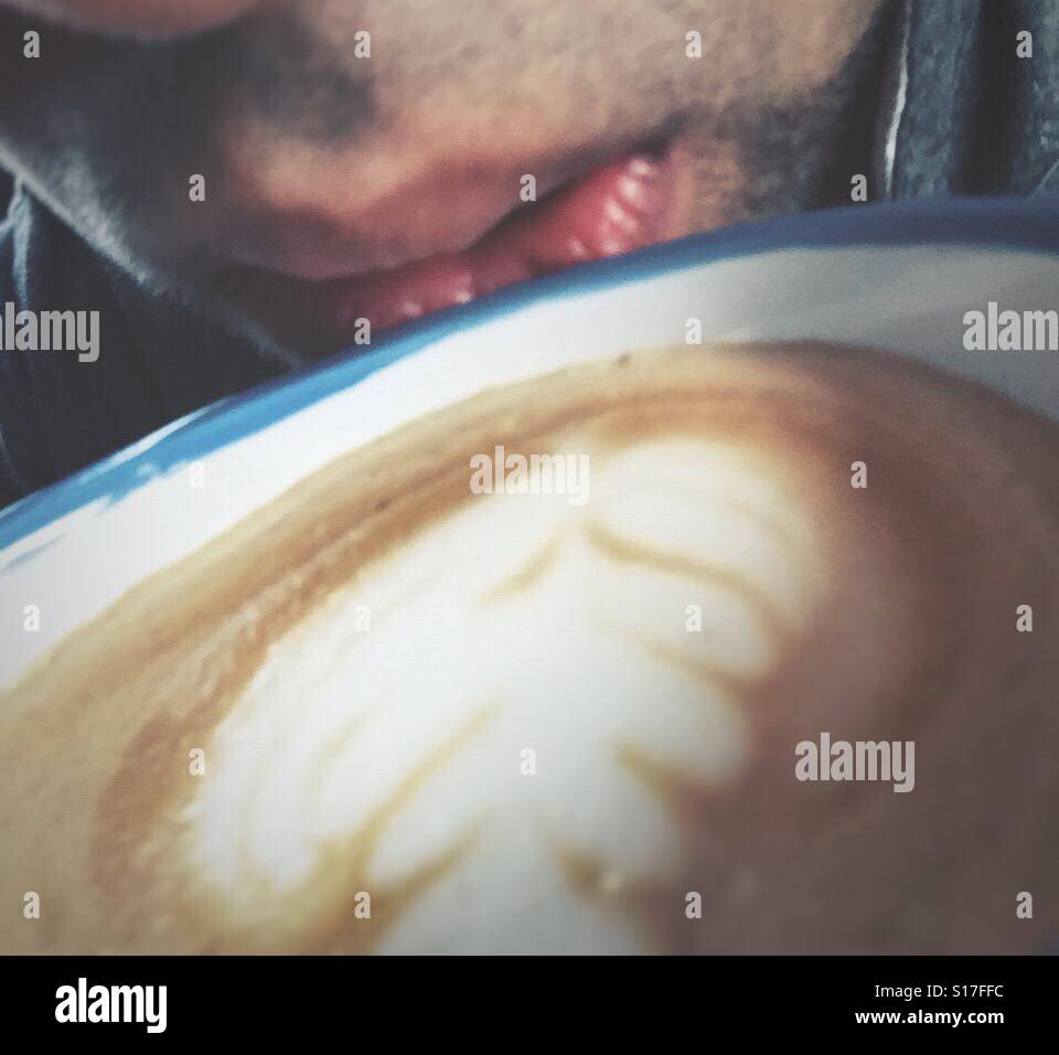 A guy drinking coffee. - Smartphone Captured Stock Image