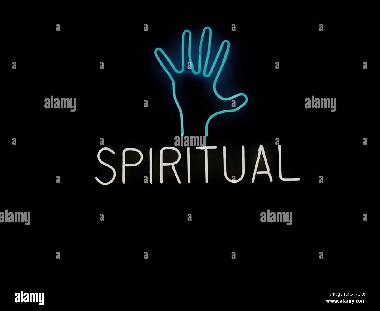 A neon sign with a hand and the word spiritual Stock Photo