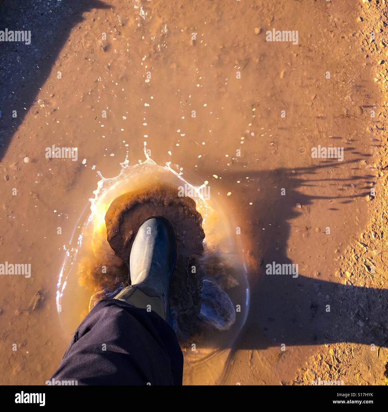 Big splash in a muddy puddle of water - Smartphone Captured Stock Image