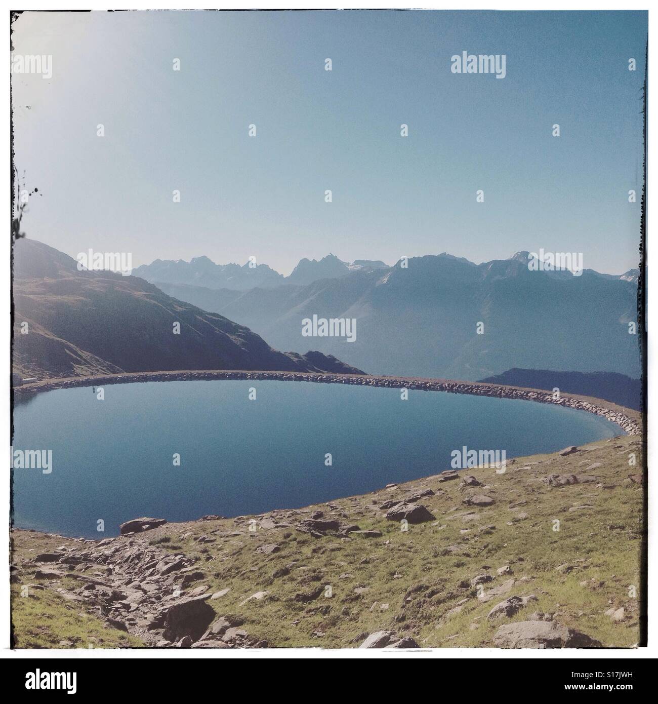 A man-made lake close to Belalp, on the trail to the Sparrhorn - Smartphone Captured Stock Image