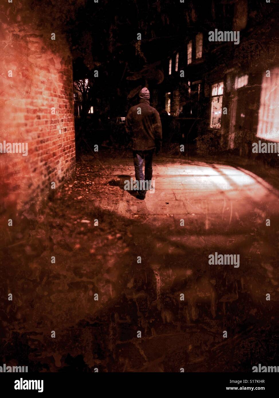 Man walking along footpath at night England UK - Smartphone Captured Stock Image