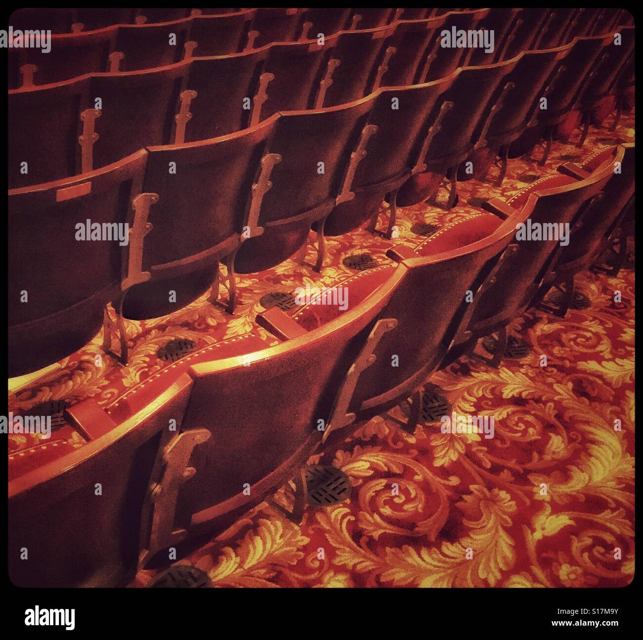 An empty theatre showing rows of empty seats - the performance has just finished and all the audience has departed. Photo Credit - © COLIN HOSKINS. - Smartphone Captured Stock Image