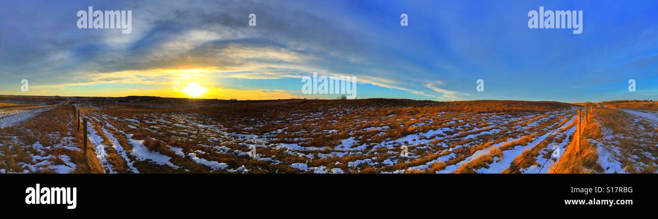 Winter sunset in a rural place with roads and fences - Smartphone Captured Stock Image