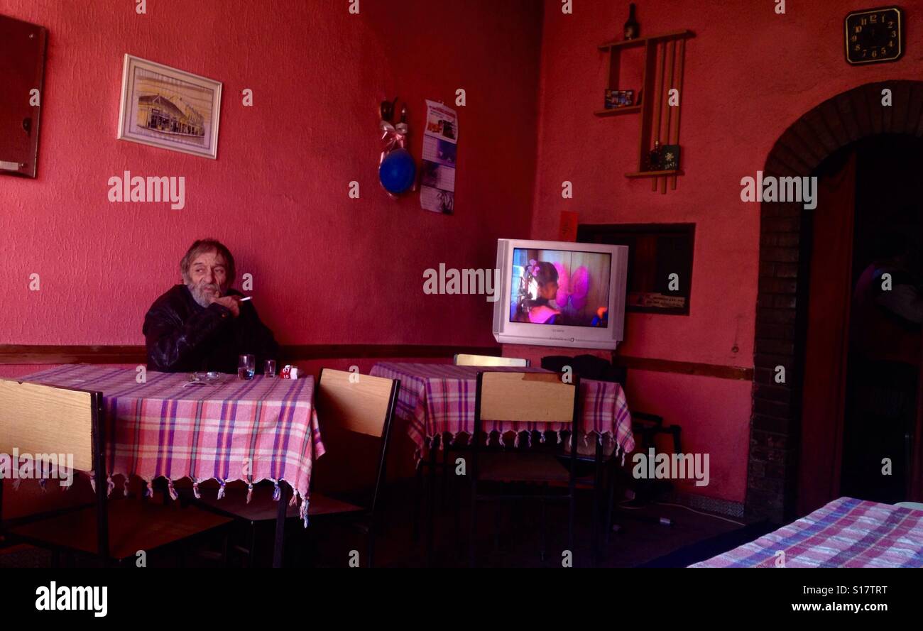 Old retired school teacher contemplating in a tavern looking out of the window - Smartphone Captured Stock Image