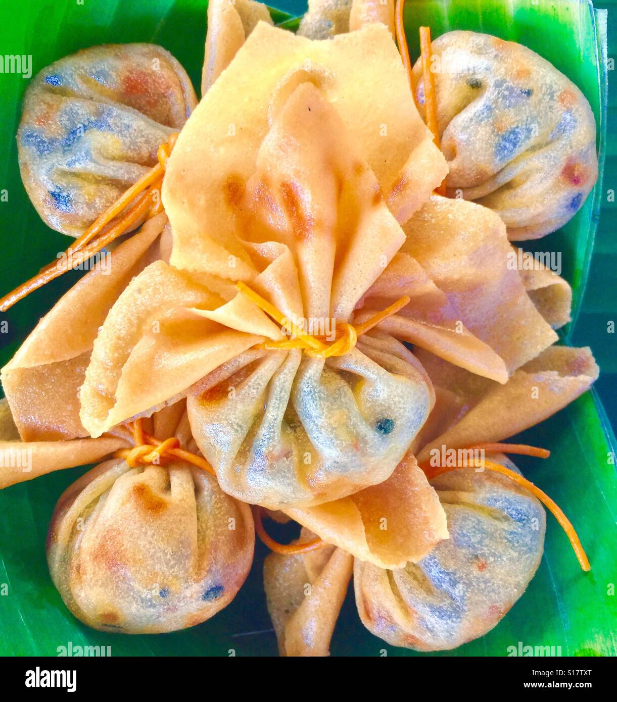 Thai snack - Fried dumplings  on banana leaf,Samut Songkhram Stock Photo