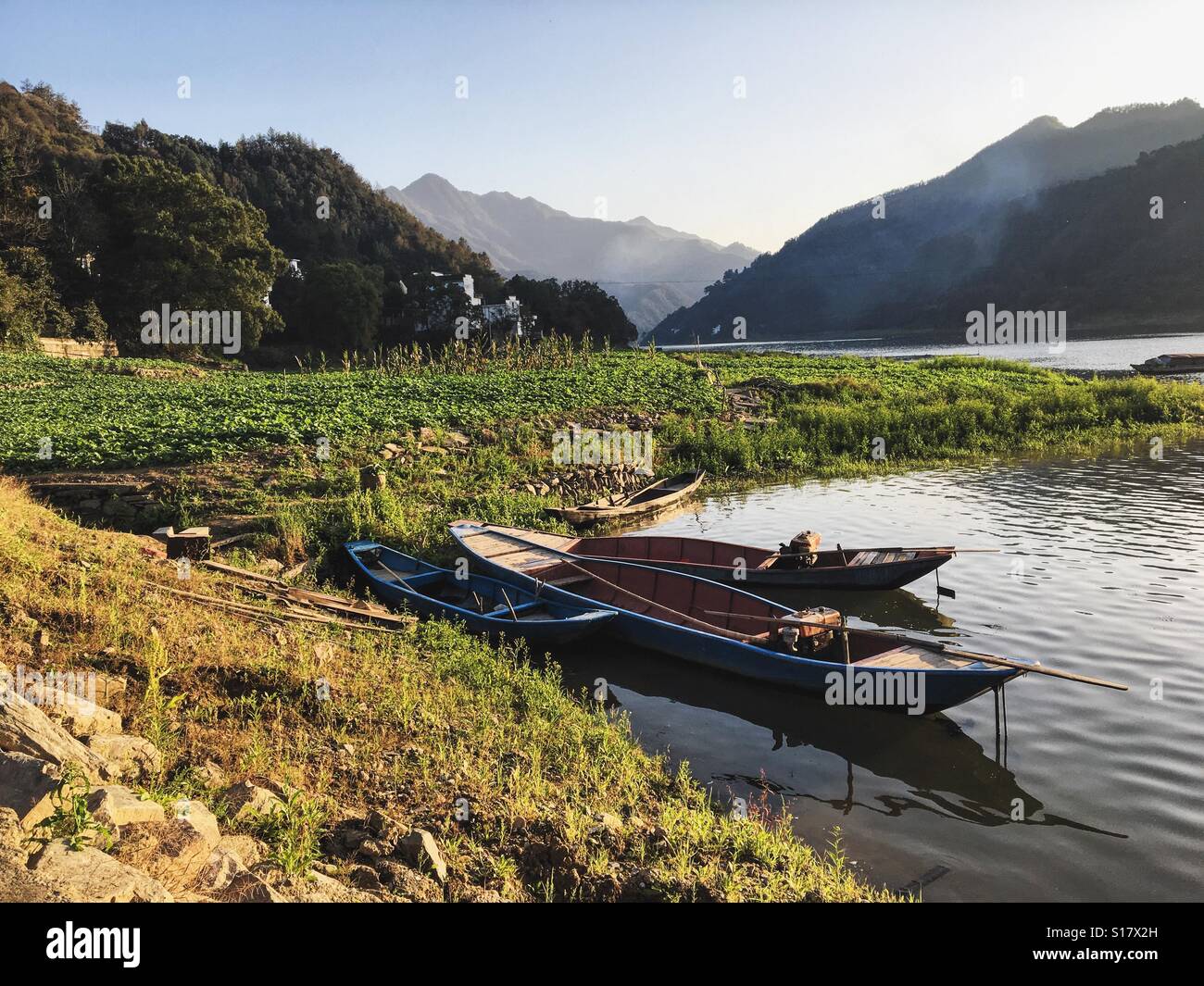 Mountain views and fishing boats. Stock Photo