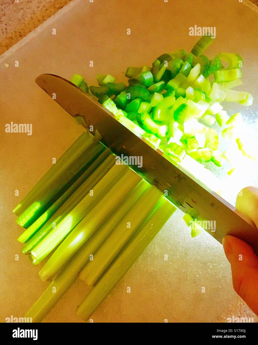 chopping celery for soup Stock Photo Alamy