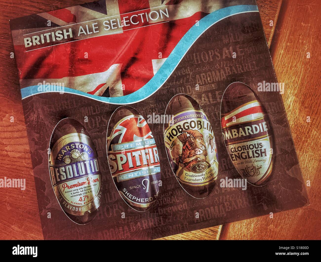 A grunge effect picture of a gift box of British Ales and Beers. There are 4 bottles in the pack - Resolution, Spitfire, Hobgoblin & Bombardier. Photo Credit - © COLIN HOSKINS. - Smartphone Captured Stock Image