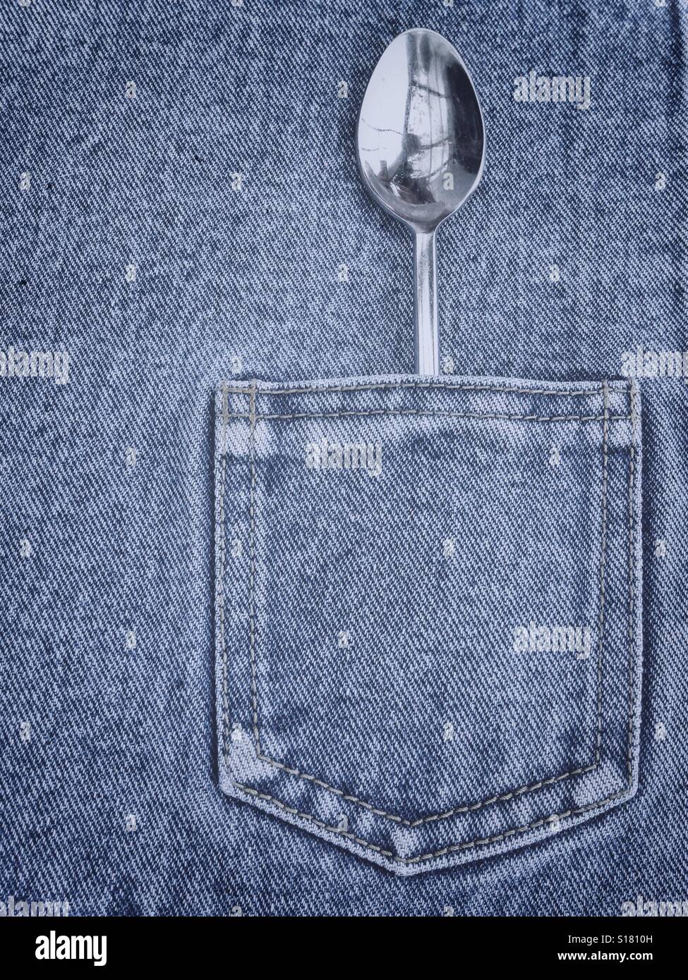 A spoon in a pocket of jeans tablecloth Stock Photo - Alamy