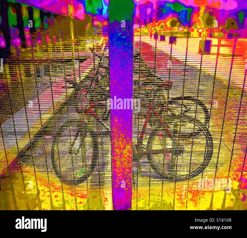 Line of bicycles parked outside a sports centre in Madrid, Spain, as viewed through the shuttered window of the entrance thereto. Stock Photo