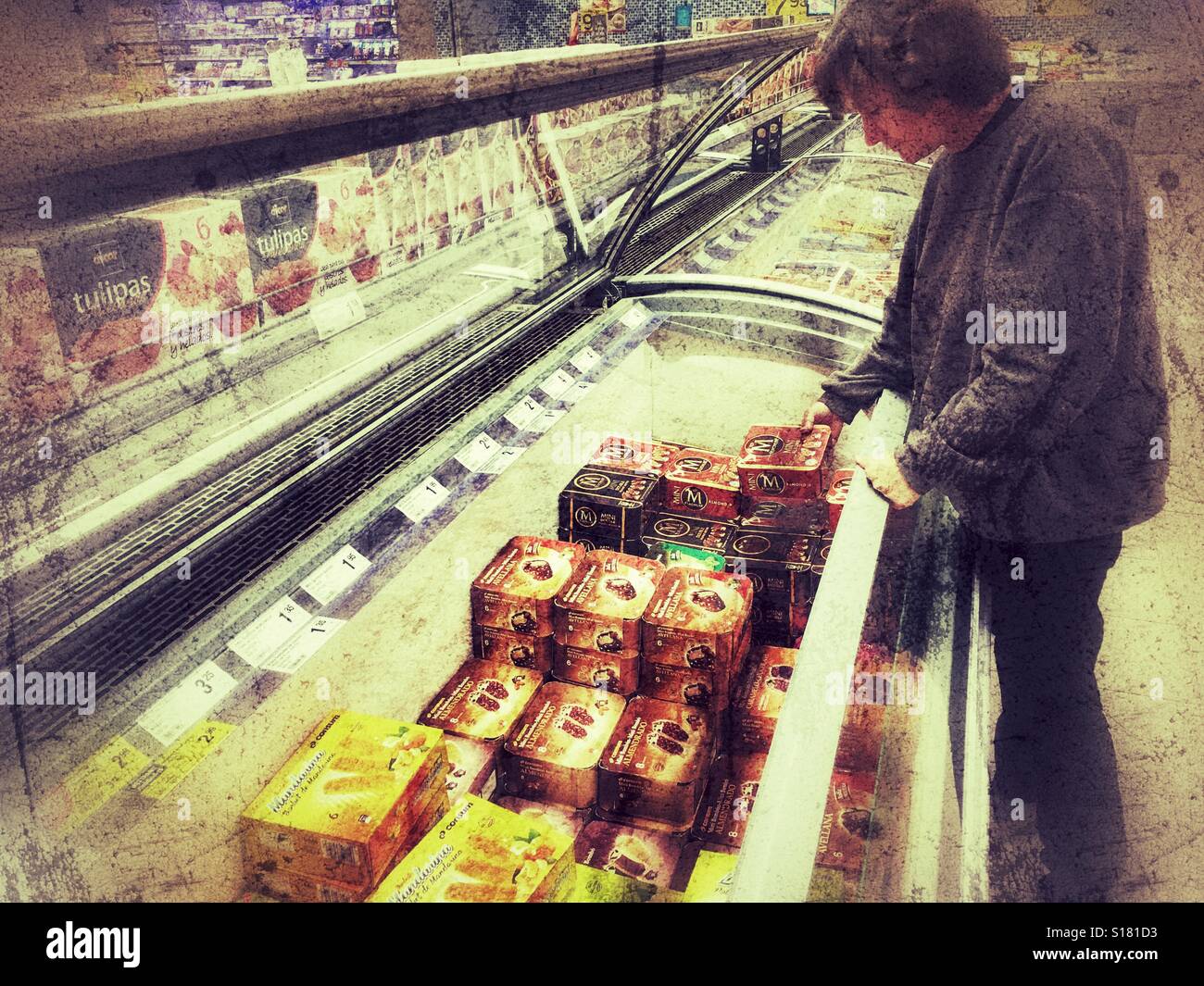 Woman choosing ice cream from a supermarket freezer Stock Photo