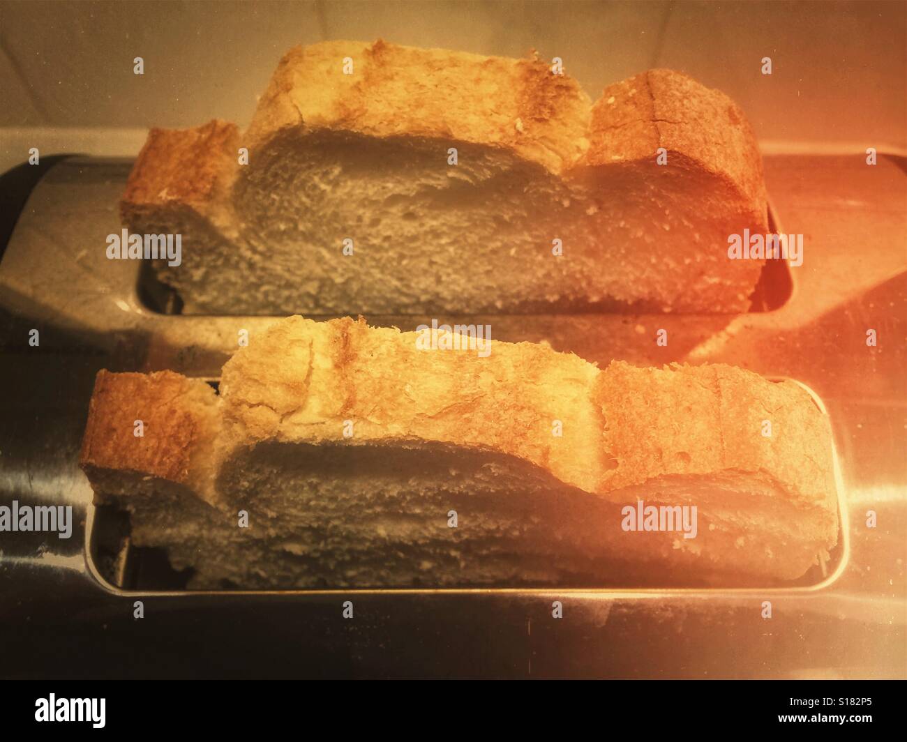 Making toast. Two thick slices of bread in the toaster Stock Photo Alamy